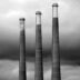 grayscale photo of three different height lighthouses
