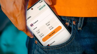 Smartphone displaying travel information in a pocket.