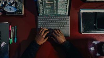 A person sitting at a desk with a laptop