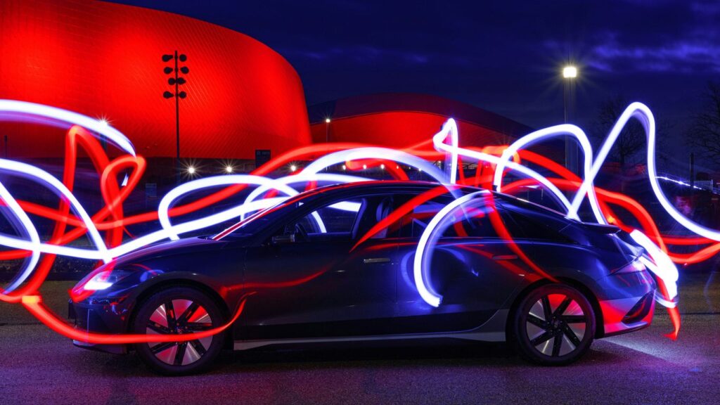 a car parked in front of a red building