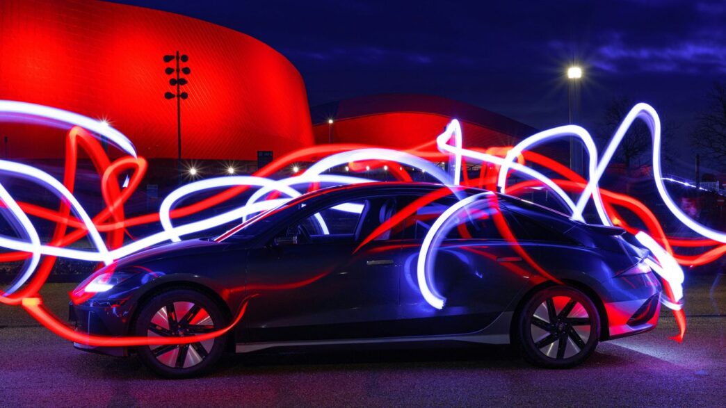 a car parked in front of a red building