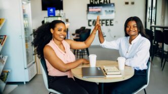 A couple of women sitting at a table