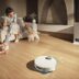 Robot vacuum cleans floor while family relaxes