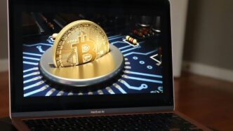 a laptop with a bitcoin on the screen