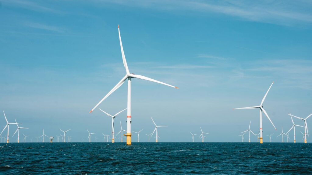 a group of wind turbines in the ocean