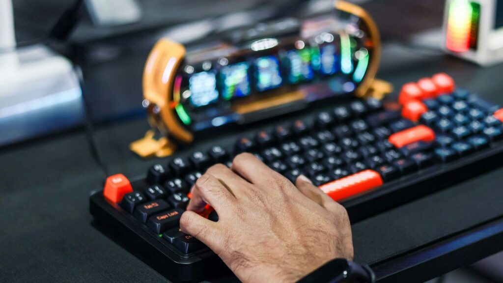 Person's hand typing on a gaming keyboard