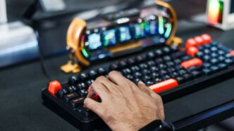 Person's hand typing on a gaming keyboard