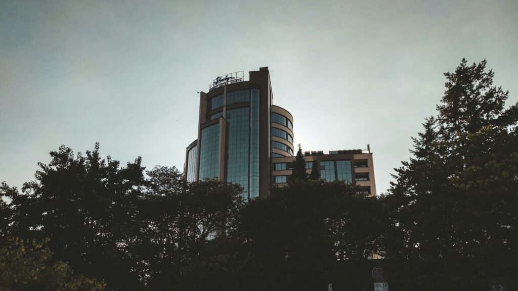 a tall building with trees in front of it
