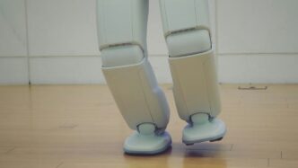 a robot standing on top of a hard wood floor