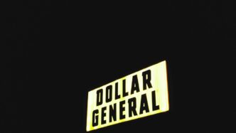 a street sign that reads dollar general at night