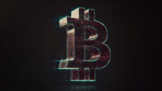 A shiny bitcoin logo on a black background