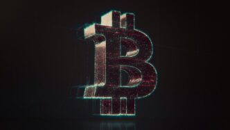 A shiny bitcoin logo on a black background