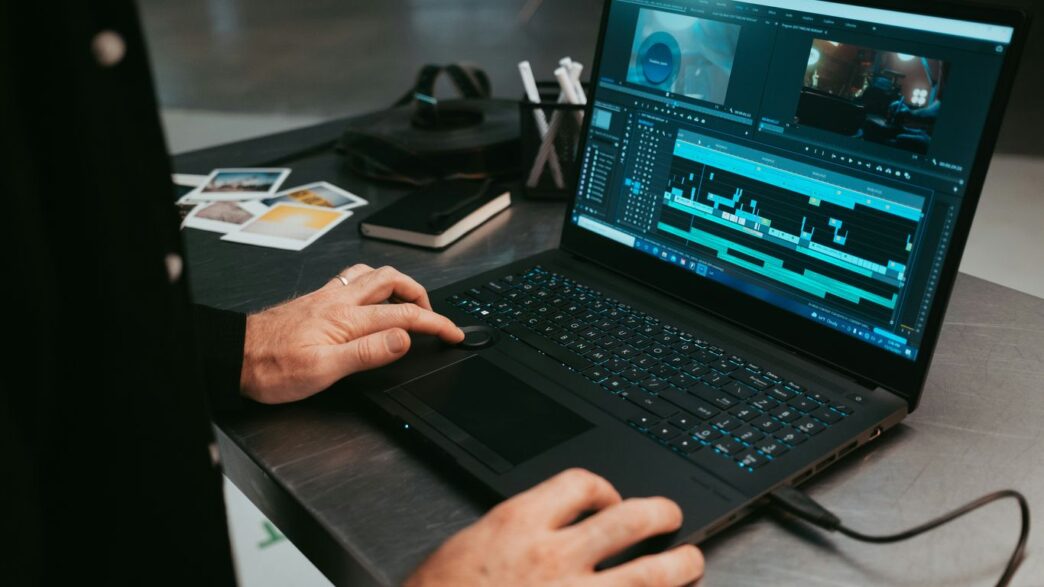 a man sitting at a table using a laptop computer