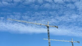 a group of metal towers with smoke coming out of them
