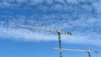 a group of metal towers with smoke coming out of them