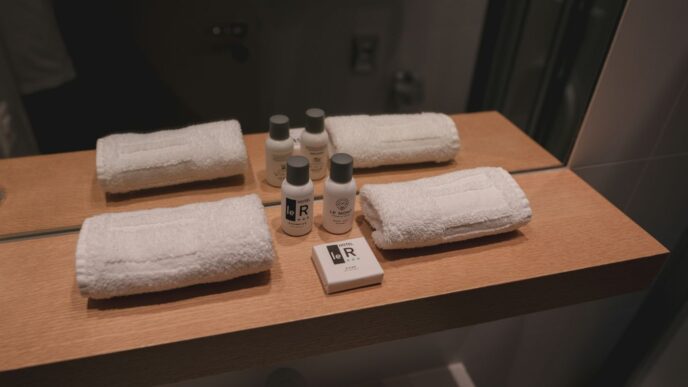 a wooden counter topped with bottles and towels
