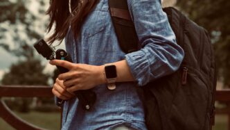 woman in blue denim jacket and blue denim jacket holding black dslr camera