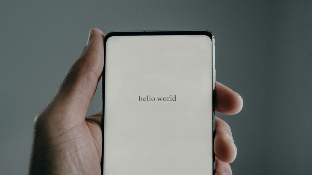 a person holding a cell phone in their hand