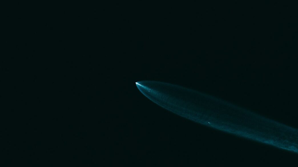 A close up of a surfboard in the dark