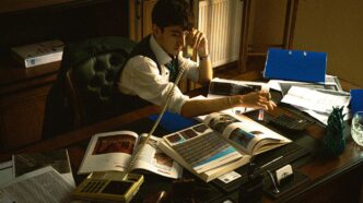A person sitting at a desk with a laptop