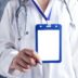 person in white and blue medical scrub holding blue and white card