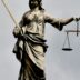 A statue of lady justice holding a sword and a scale