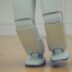 a robot standing on top of a hard wood floor