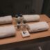 a wooden counter topped with bottles and towels