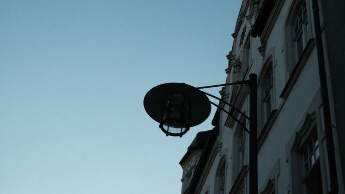 black street light on gray concrete building during daytime