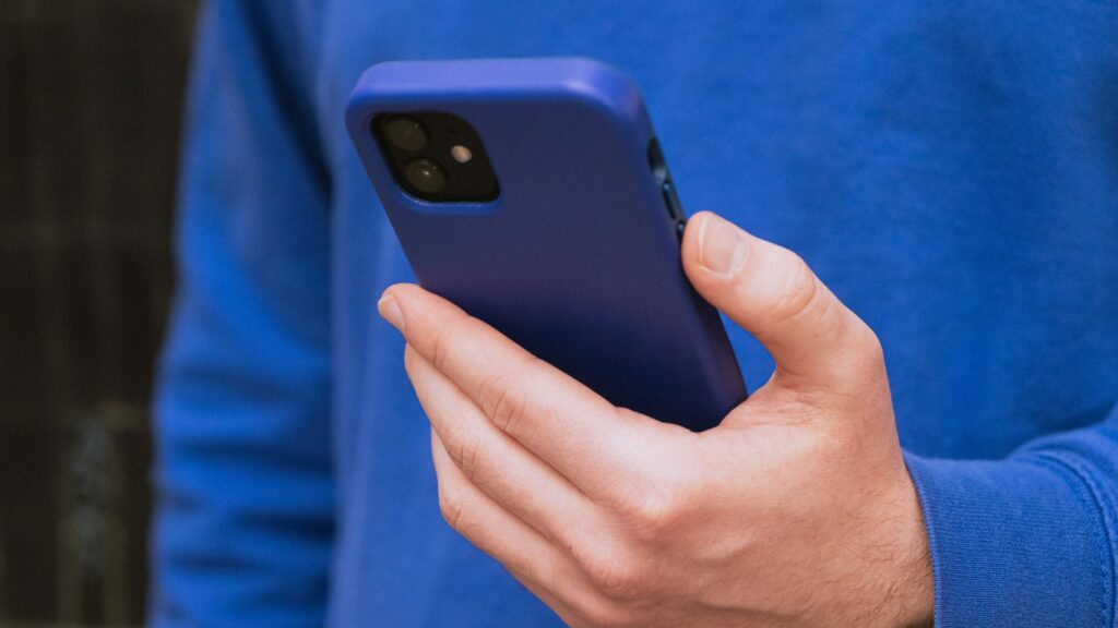 a close up of a person holding a cell phone