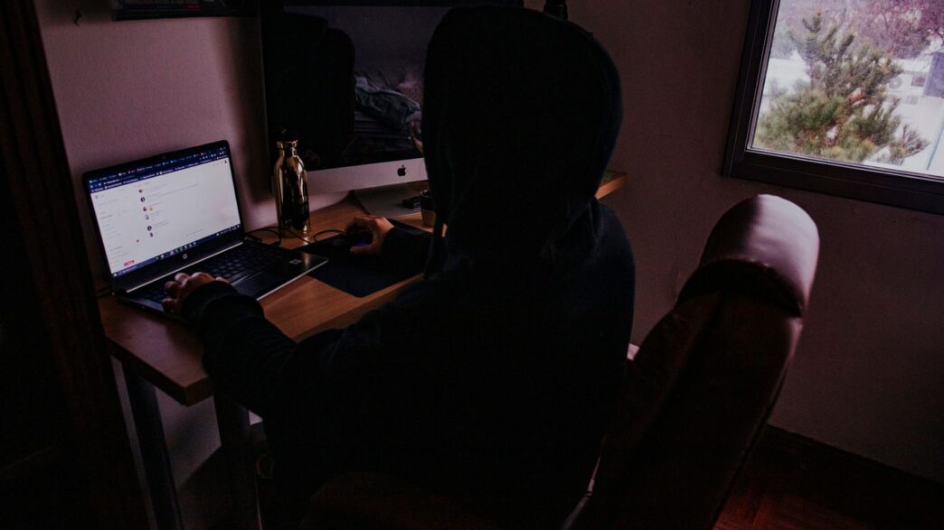 person sitting on chair in front of computer