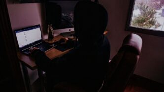 person sitting on chair in front of computer