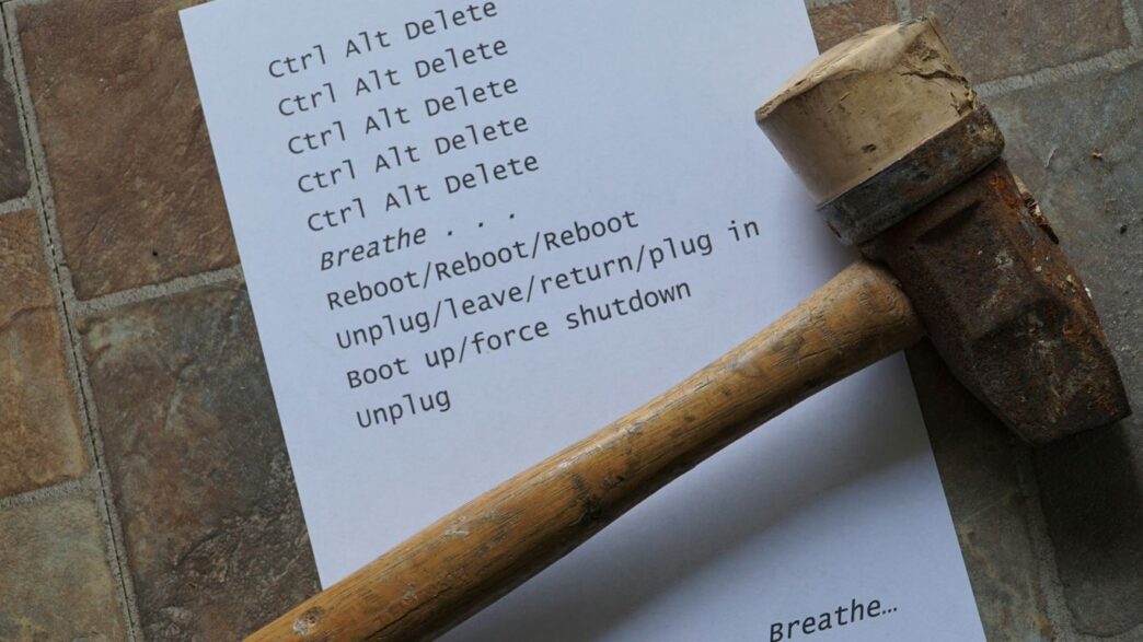 a hammer and a piece of paper on a brick floor