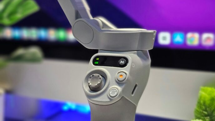 A close up of a video game controller in front of a computer