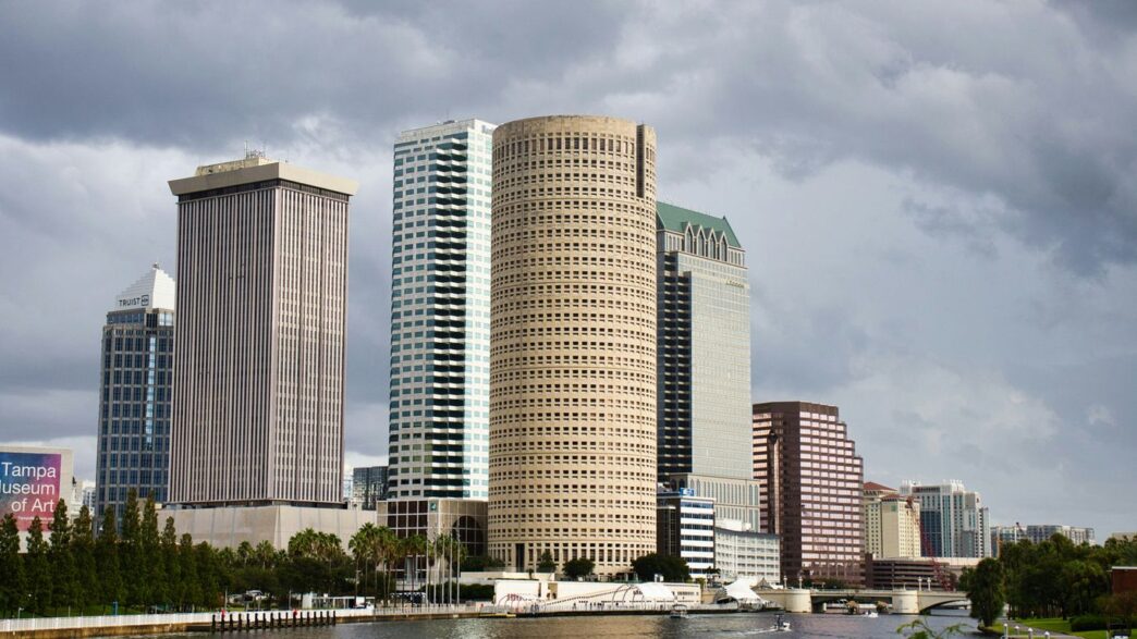 Modern cityscape with tall buildings by the water.