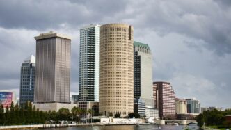 Modern cityscape with tall buildings by the water.
