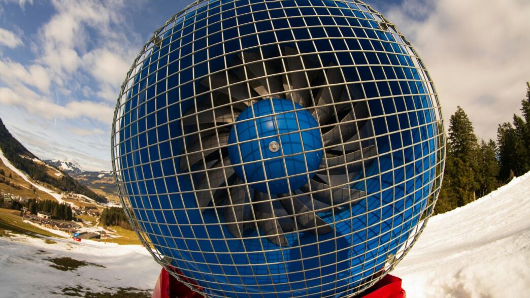 a large blue ball sitting on top of a snow covered ground
