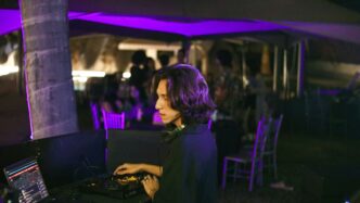 A woman sitting at a table with a laptop