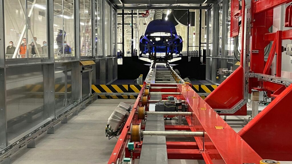 a car being built in a large factory