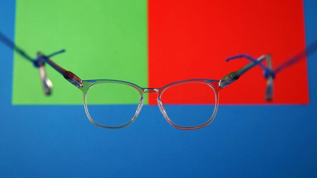 a pair of glasses on a green surface