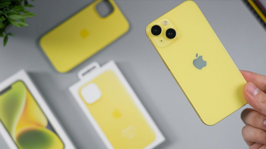 Yellow iPhone with protective cases and packaging