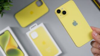 Yellow iPhone with protective cases and packaging