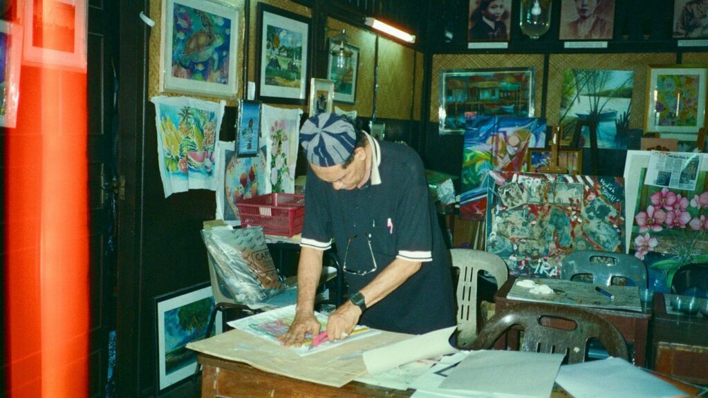 a man working on a piece of art in a room