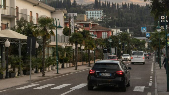 a car driving down a street next to tall buildings