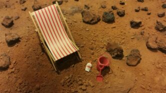 red and white striped folding bed on brown sand