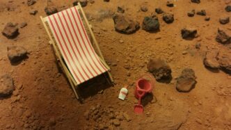 red and white striped folding bed on brown sand