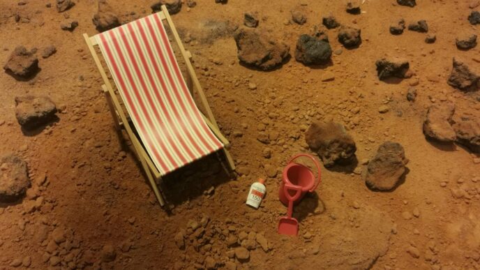 red and white striped folding bed on brown sand