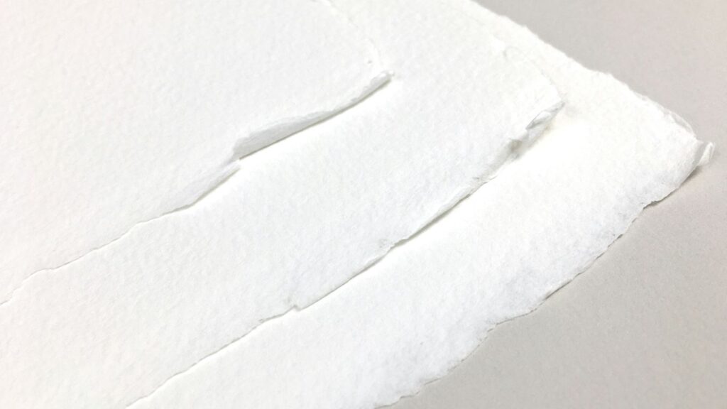 a piece of white paper with a hole in it