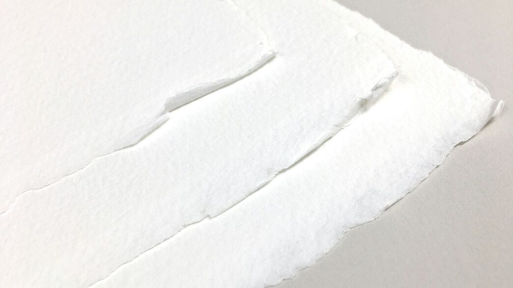 a piece of white paper with a hole in it