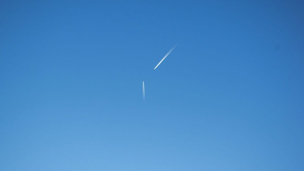 an airplane is flying high in the sky